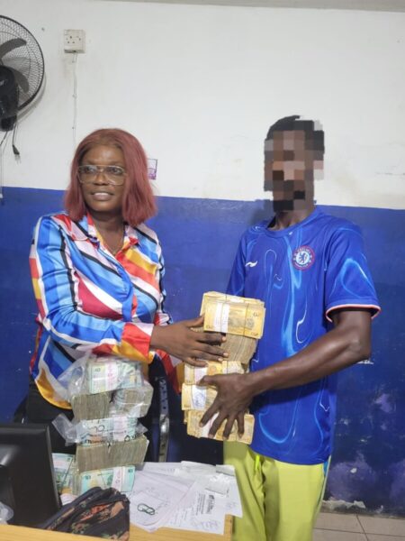 Smith Cole Receiving His Winning Cash From a Mercury Staff