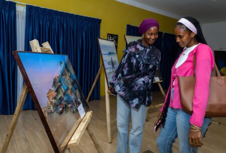 Image: Two female guests staring at one of the images on display