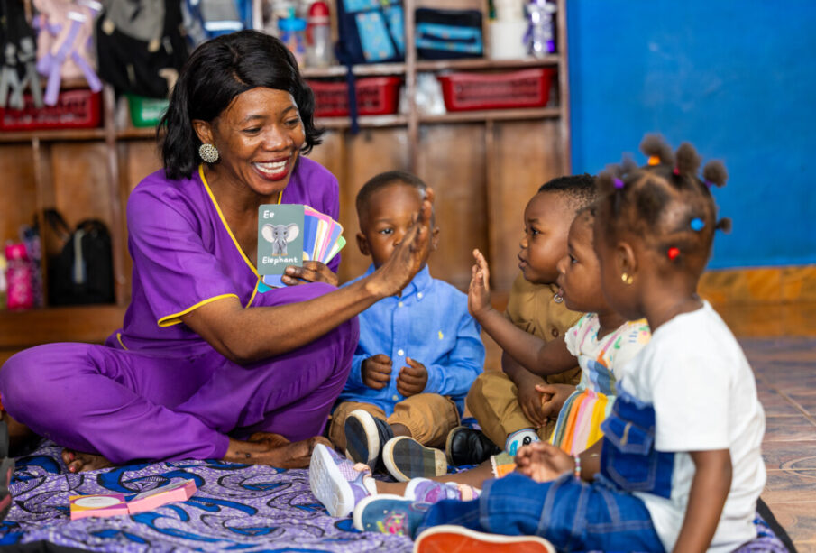A learning coach uses Yak Jones Foundation African - inspired alphabet flash cards and Sierra Leone landmark puzzles