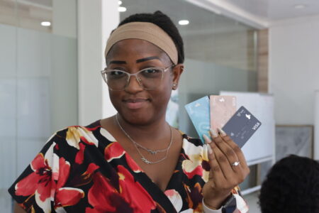 Iris Olu-Williams a staff of vult posing with her cards