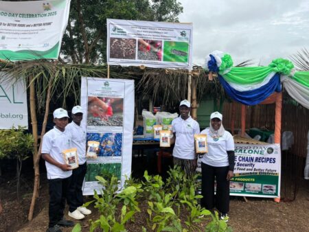 Mohamed Samu (middle) and staff holding EntoTech product