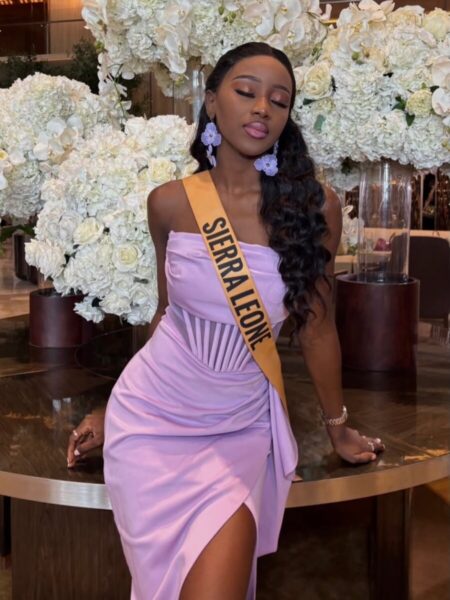 Caroline Adel Jusu poses in a lavender gown at a Miss Grand International event