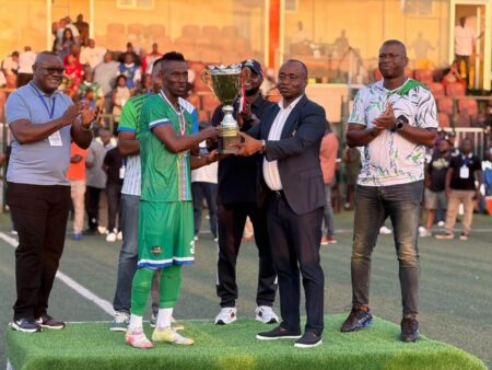 SLFA President Babadi Kamara handing over the Unity Trophy to Bo Rangers