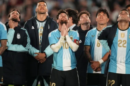 Messi in the middle and other Argentina players looking at the fans reactions