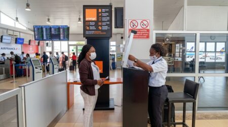 A passenger going through screening at the Freetown International airport