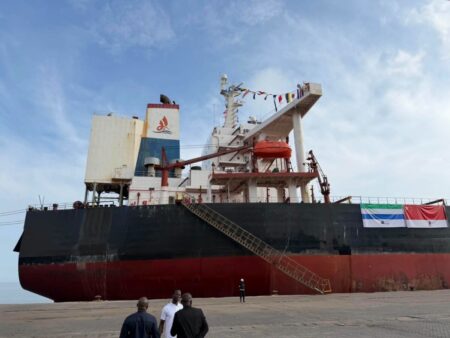 A sideview of the ship with China and Sierra Leone Flag